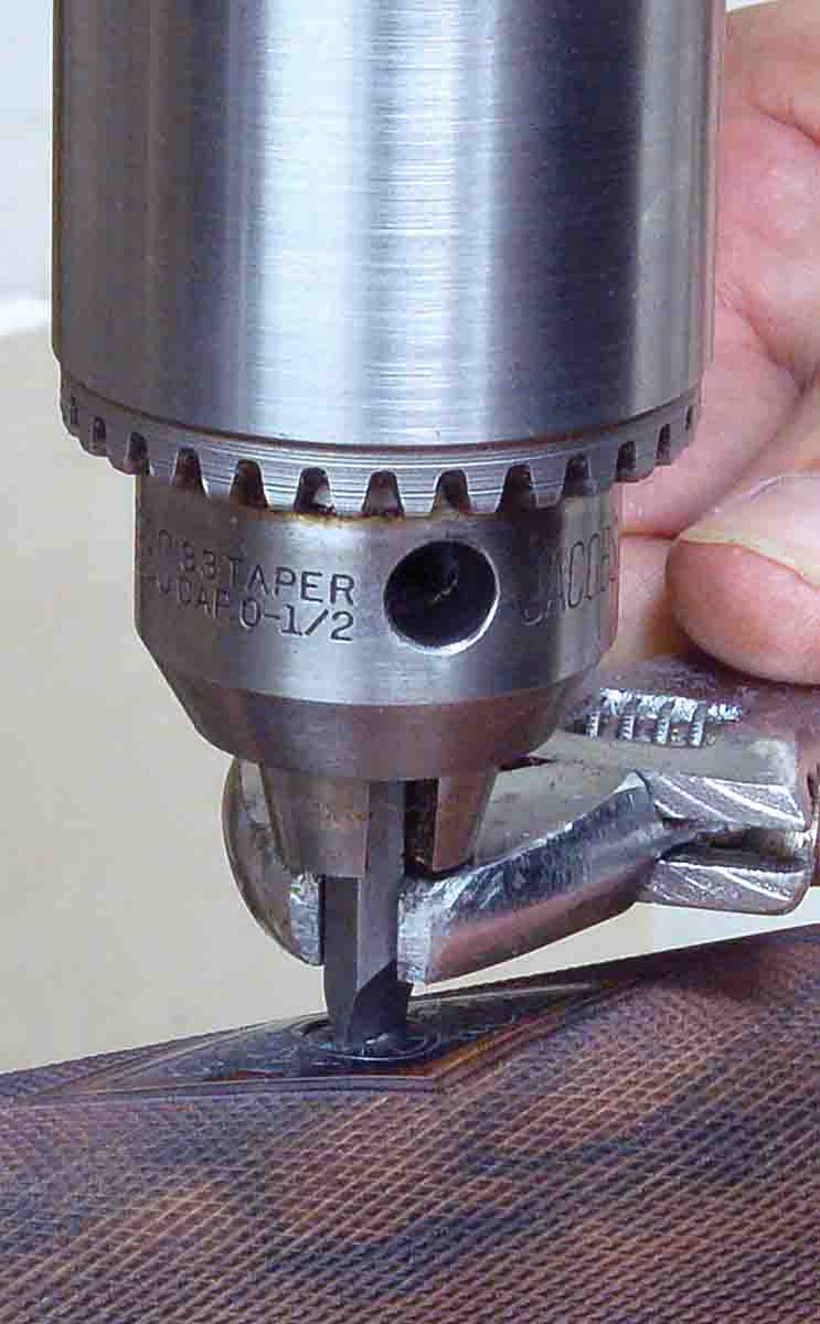 If more persuasion is required, a screwdriver bit held in a drill press chuck can be forced into the screw slot and turned with a wrench.